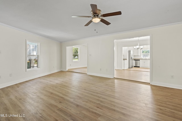 122 Carroll Ave, Long Beach, MS 39560 - unfurnished living room featuring crown molding, a chandelier, light wood finished floors, and a ceiling fan