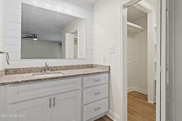 122 Carroll Ave, Long Beach, MS 39560 - bathroom with wood finished floors, vanity, and a ceiling fan
