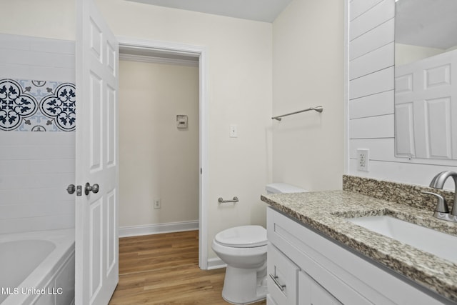 122 Carroll Ave, Long Beach, MS 39560 - bathroom featuring vanity, a bathtub, and wood finished floors