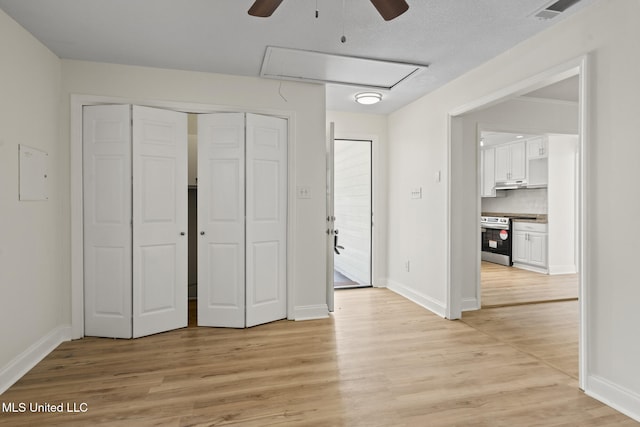 122 Carroll Ave, Long Beach, MS 39560 - unfurnished bedroom featuring attic access, light wood-type flooring, and ceiling fan
