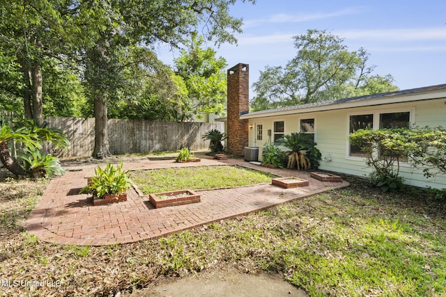 122 Carroll Ave, Long Beach, MS 39560 - fenced backyard with a patio and a fire pit