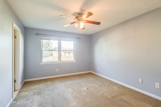 unfurnished room featuring ceiling fan, light carpet, and a textured ceiling