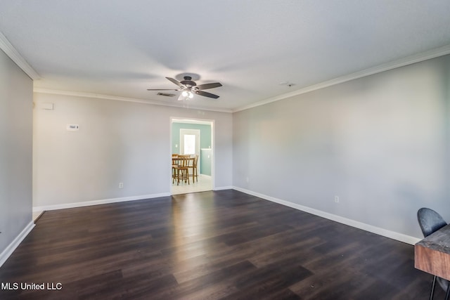 unfurnished room featuring ornamental molding, ceiling fan, and dark wood-type flooring