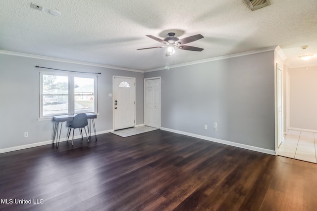 foyer entrance featuring ceiling fan, dark wood-type flooring, and crown molding