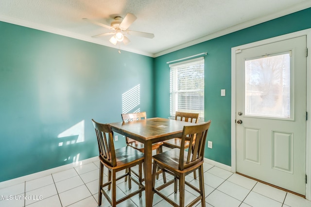 dining space with crown molding, a textured ceiling, ceiling fan, and light tile patterned floors