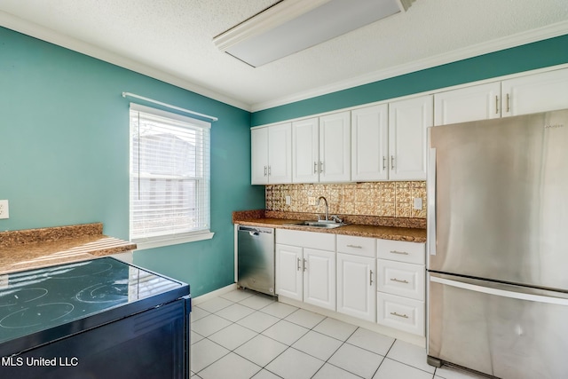 kitchen with white cabinets, stainless steel appliances, light tile patterned floors, sink, and backsplash