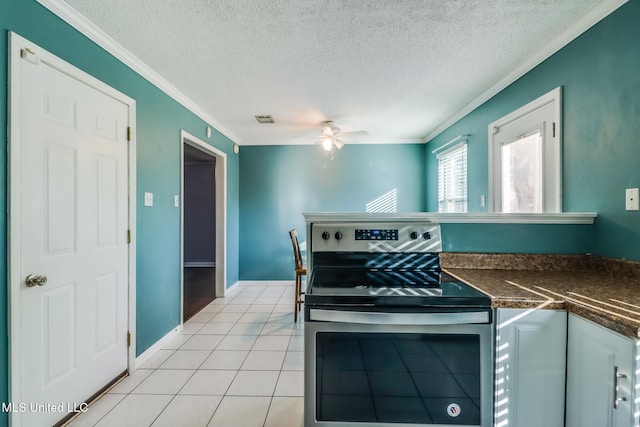 kitchen featuring stainless steel electric range, ornamental molding, light tile patterned floors, and ceiling fan