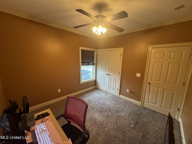 unfurnished office featuring carpet flooring, ceiling fan, ornamental molding, and a textured ceiling