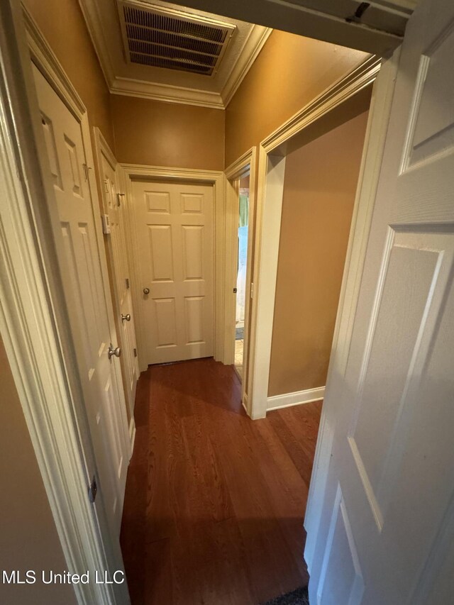hall with crown molding and dark wood-type flooring