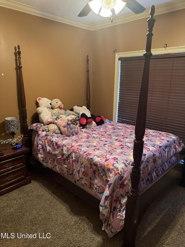 bedroom with carpet flooring, ceiling fan, and crown molding