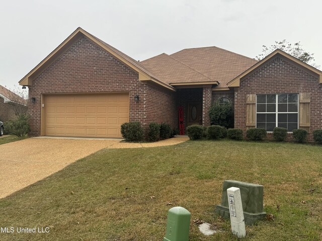 view of front of property with a front yard and a garage