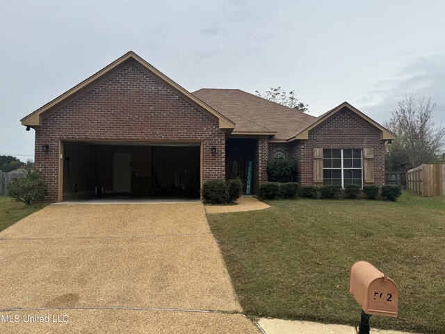 single story home with a front yard and a garage