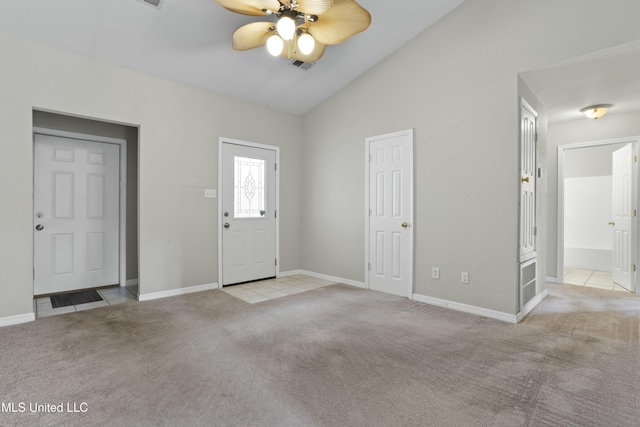 carpeted foyer with ceiling fan and lofted ceiling