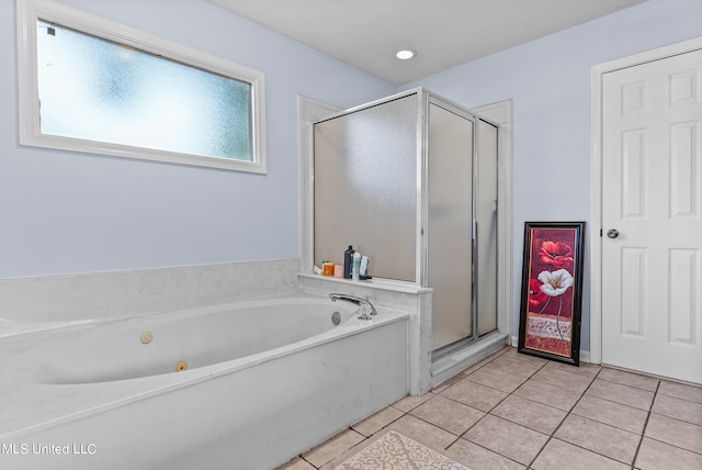 bathroom with tile patterned floors and shower with separate bathtub