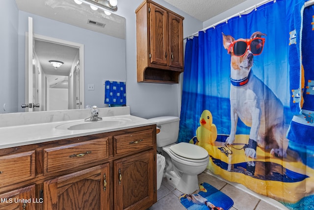 bathroom featuring a textured ceiling, walk in shower, toilet, vanity, and tile patterned floors