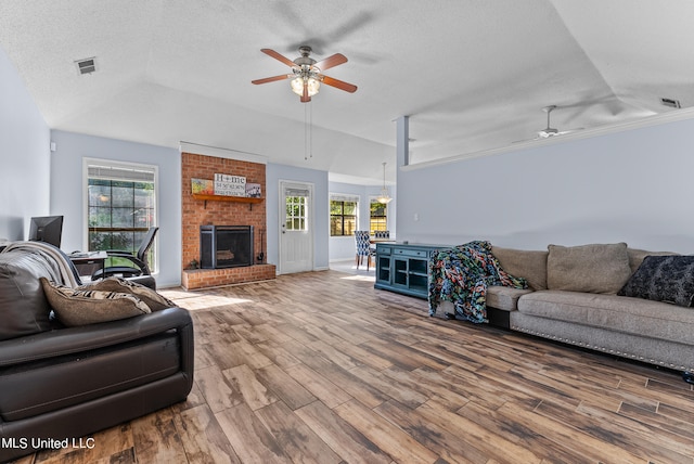 living room with ceiling fan, hardwood / wood-style flooring, and plenty of natural light