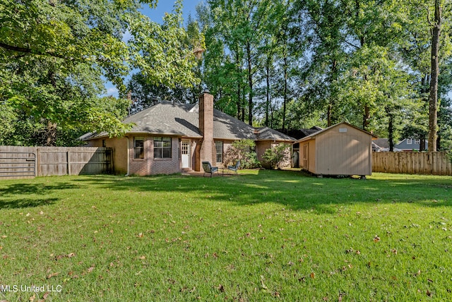 back of house with a storage shed and a lawn