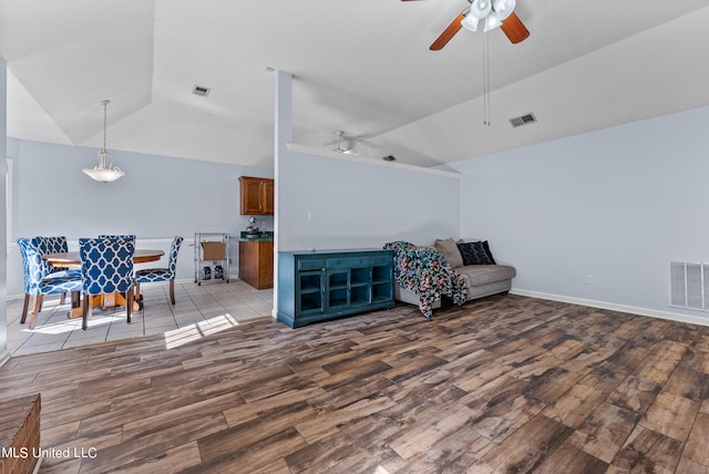 sitting room with lofted ceiling, light wood-type flooring, and ceiling fan