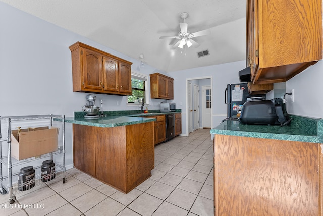 kitchen with sink, light tile patterned flooring, dishwasher, ceiling fan, and vaulted ceiling