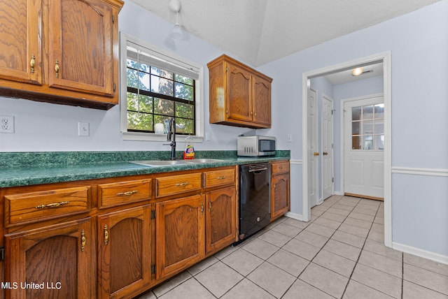 kitchen featuring sink, light tile patterned floors, a textured ceiling, and dishwasher