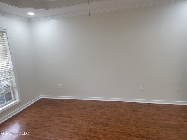 empty room featuring recessed lighting, baseboards, crown molding, and dark wood-type flooring