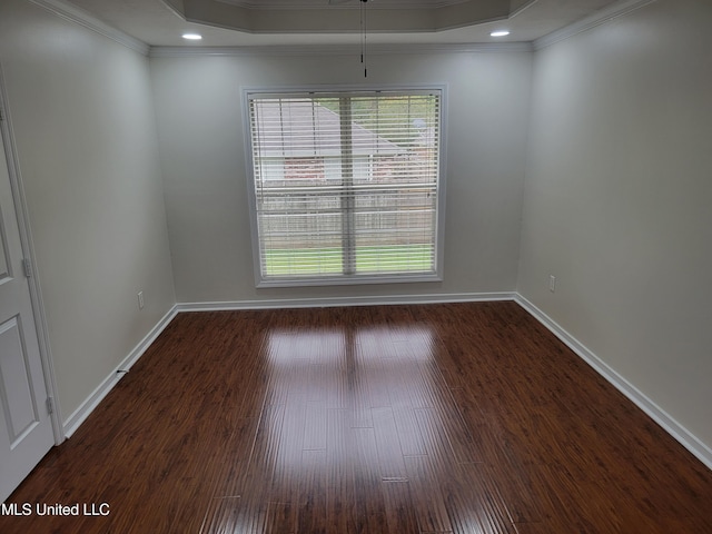 spare room with baseboards, ornamental molding, recessed lighting, wood finished floors, and a raised ceiling