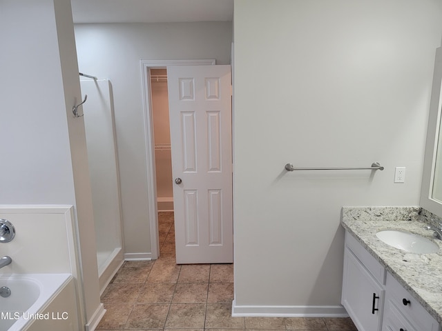 bathroom with vanity, a shower stall, a spacious closet, tile patterned floors, and a bath