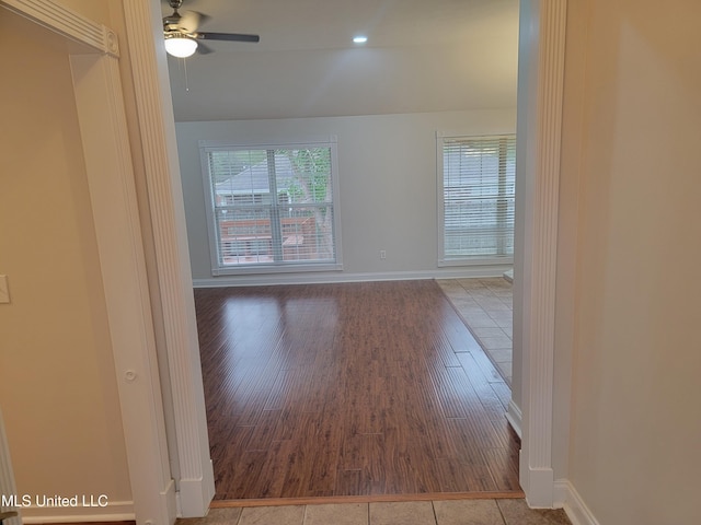 hall featuring wood finished floors and baseboards