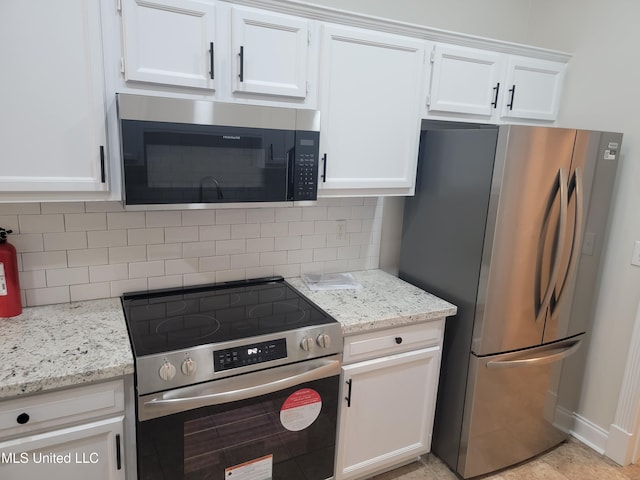 kitchen with white cabinetry, light stone countertops, backsplash, and stainless steel appliances