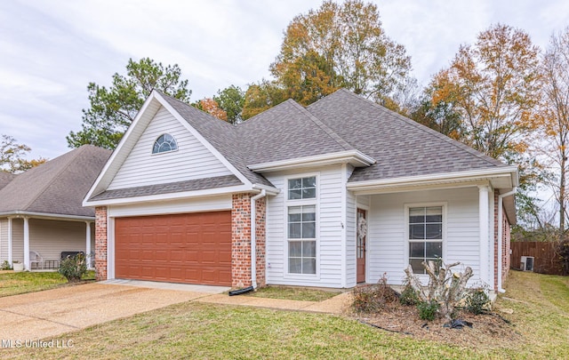 view of front of property featuring a garage, a front lawn, and cooling unit