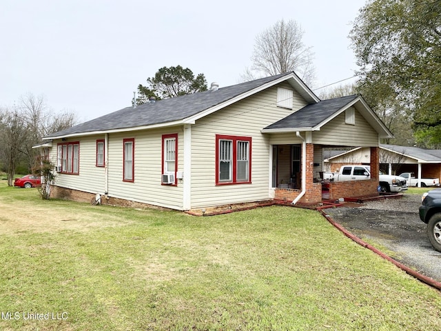 single story home featuring aphalt driveway, a front yard, brick siding, a shingled roof, and cooling unit