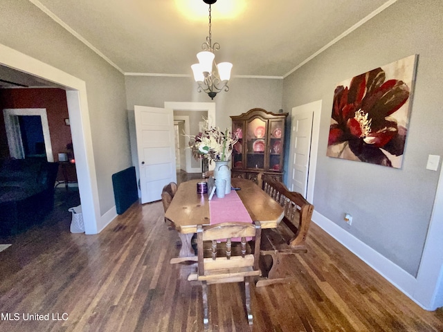 dining room with ornamental molding, baseboards, a chandelier, and wood finished floors