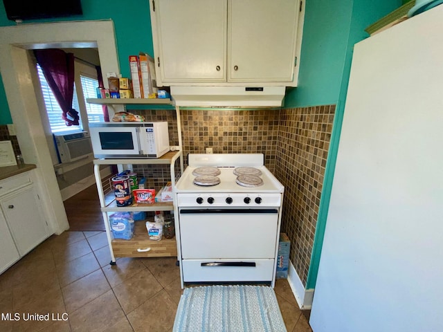 kitchen featuring cooling unit, tile walls, white appliances, under cabinet range hood, and tile patterned floors