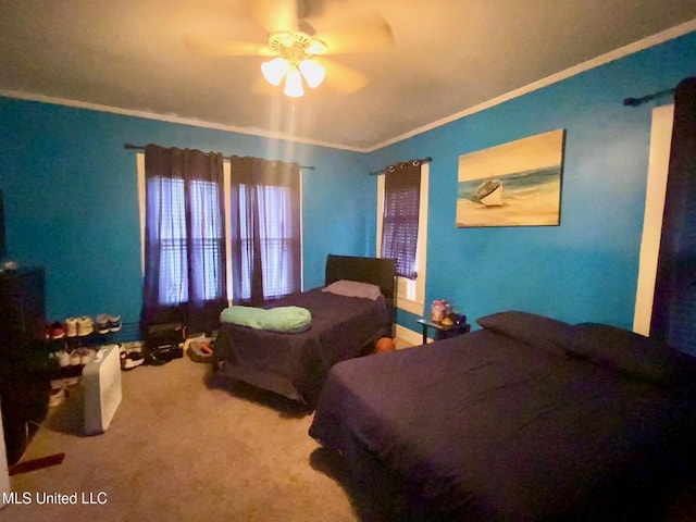 carpeted bedroom featuring crown molding and ceiling fan
