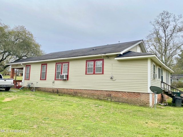 view of property exterior featuring cooling unit and a lawn