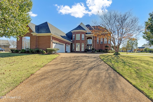 view of front of house featuring a front lawn and a garage