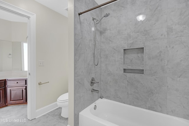 full bathroom with vanity, tiled shower / bath, and toilet