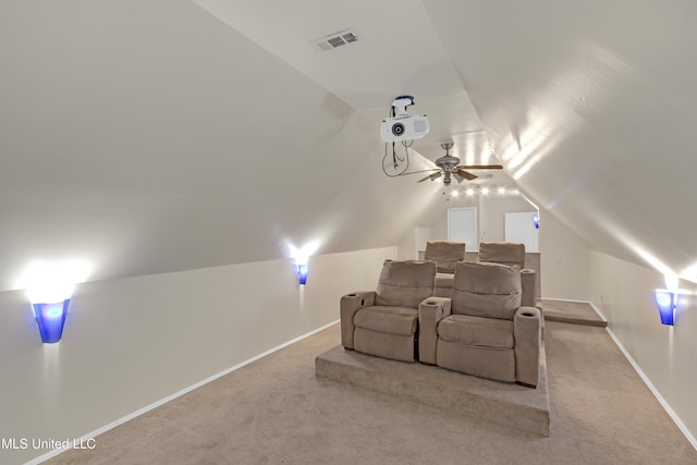 home theater with lofted ceiling and light carpet