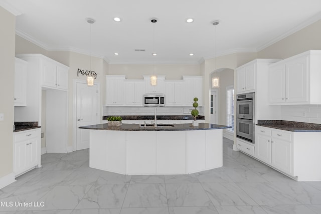 kitchen featuring sink, hanging light fixtures, a center island with sink, white cabinets, and appliances with stainless steel finishes