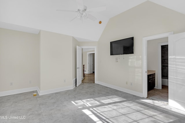 unfurnished bedroom with ensuite bathroom, vaulted ceiling, and ceiling fan