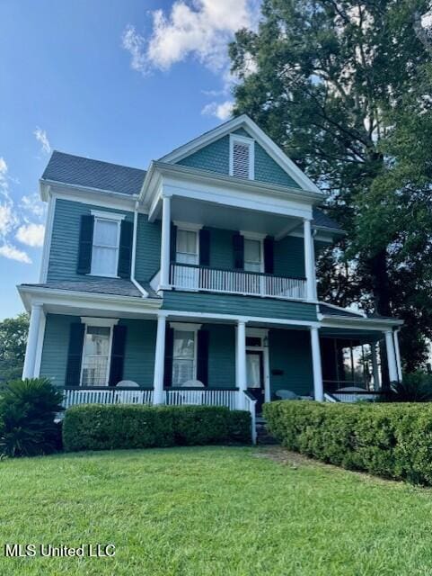 neoclassical home with a porch and a front yard