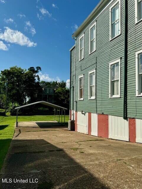 206 Linton Ave, Natchez, MS 39120 - view of property exterior with a carport and a lawn