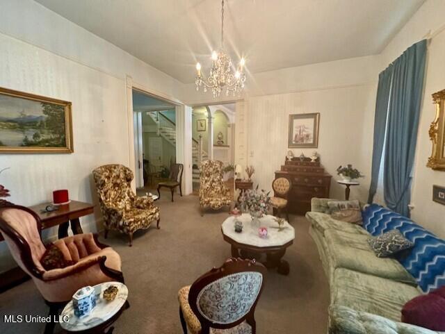 206 Linton Ave, Natchez, MS 39120 - carpeted living room featuring a chandelier and arched walkways