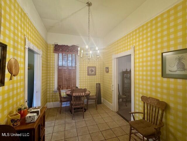 206 Linton Ave, Natchez, MS 39120 - dining space featuring a chandelier, light tile patterned flooring, and baseboards