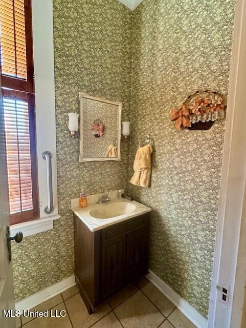 206 Linton Ave, Natchez, MS 39120 - bathroom featuring tile patterned floors, vanity, baseboards, and wallpapered walls