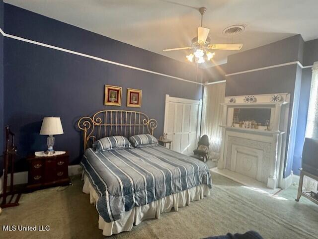 206 Linton Ave, Natchez, MS 39120 - bedroom featuring carpet flooring, a fireplace, and ceiling fan