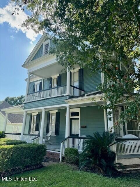 206 Linton Ave, Natchez, MS 39120 - view of front of house with a balcony, covered porch, and a front yard