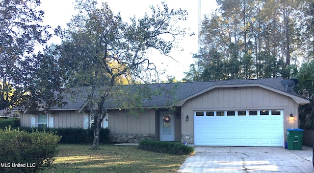 ranch-style home featuring a front yard and a garage