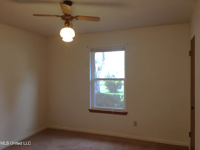 unfurnished room with ceiling fan and carpet