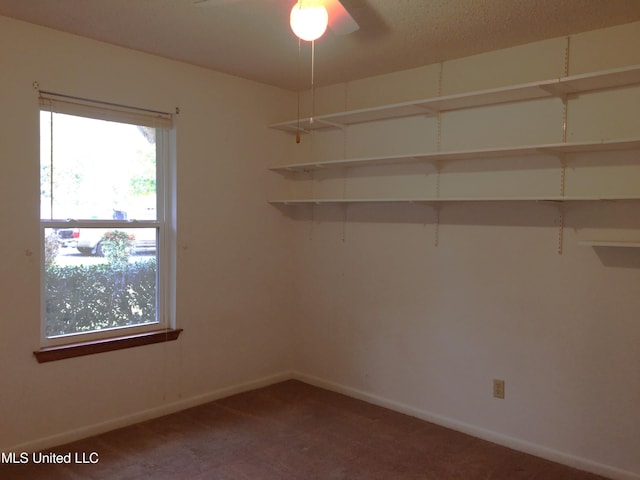 carpeted empty room featuring ceiling fan